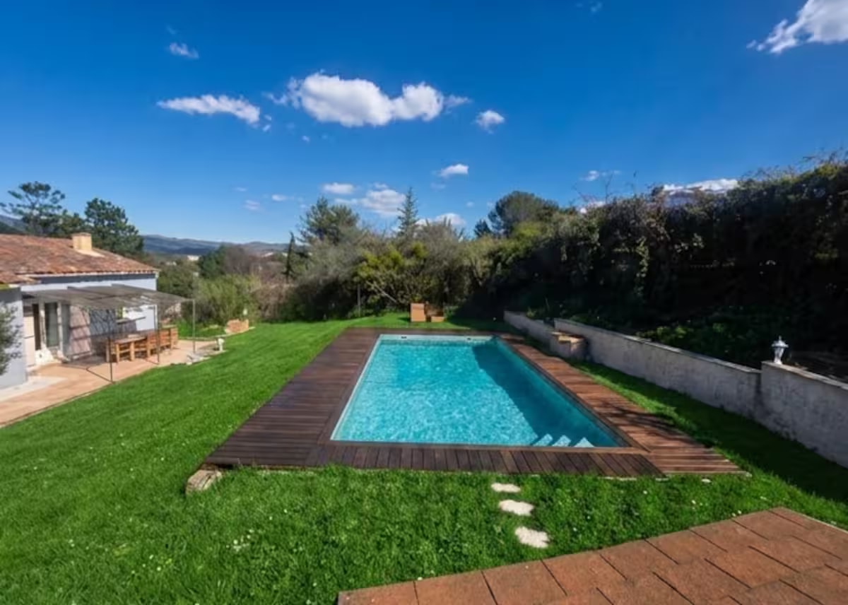 Private pool with wooden decking and garden views
